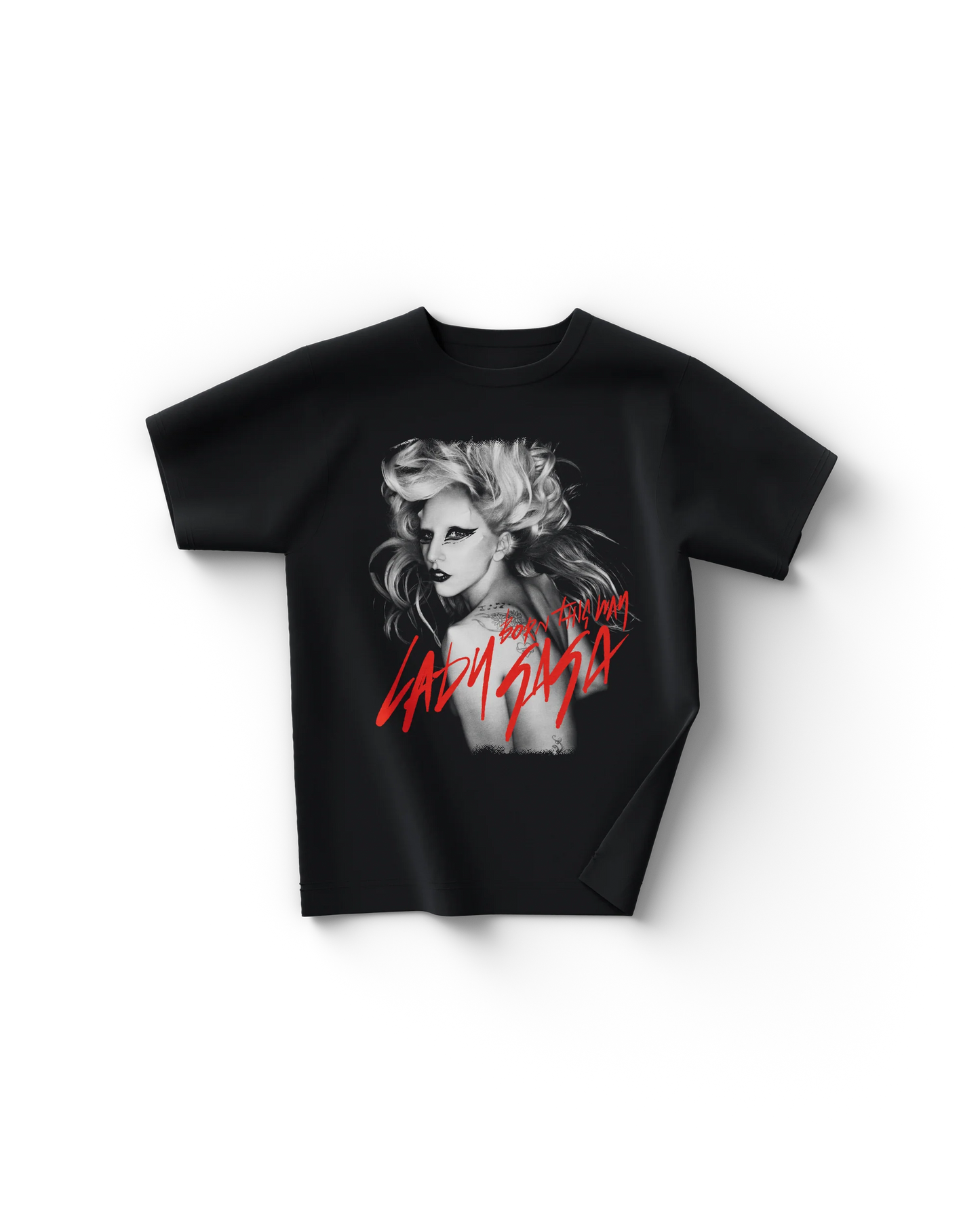 Black Lady Gaga t-shirt with a grayscale portrait of Gaga wearing bold black eyeliner and voluminous blonde hair, overlaid with red handwritten text reading “Born This Way” and “Lady Gaga.” The striking design captures Gaga’s signature theatrical style from the Born This Way era.