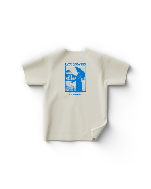 Back of cream Lady Gaga Rio t-shirt with blue concert poster graphic and Copacabana beach illustration

