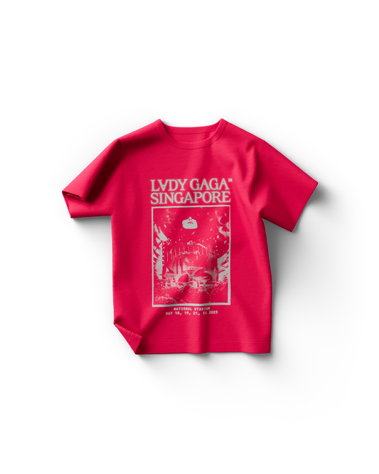 Bright pink Lady Gaga t-shirt featuring white text reading “LADY GAGA™ SINGAPORE” above a futuristic concert graphic of the National Stadium with Gaga’s face looming above. The bottom includes the 2025 tour dates: May 18, 19, 21, and 24.

