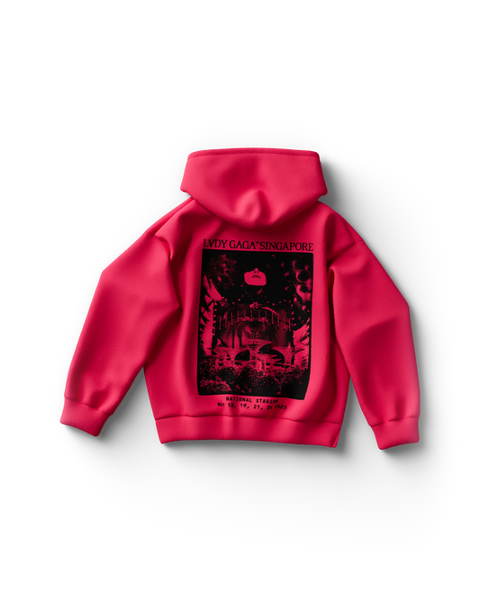 Back of bright pink Lady Gaga hoodie with black artwork showing Singapore’s National Stadium and Gaga's face in a moody, atmospheric collage. Text at the top reads “LADY GAGA™ SINGAPORE,” with tour dates—May 18, 19, 21, 24, 2025—printed at the bottom.

