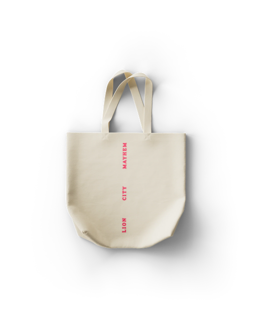 Back of Lady Gaga canvas tote featuring vertical pink text reading “LION CITY MAYHEM” down the center. Clean and minimalist with a punch of tour-exclusive flair.

